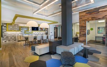 coworking lounge with a long table and blue chairs